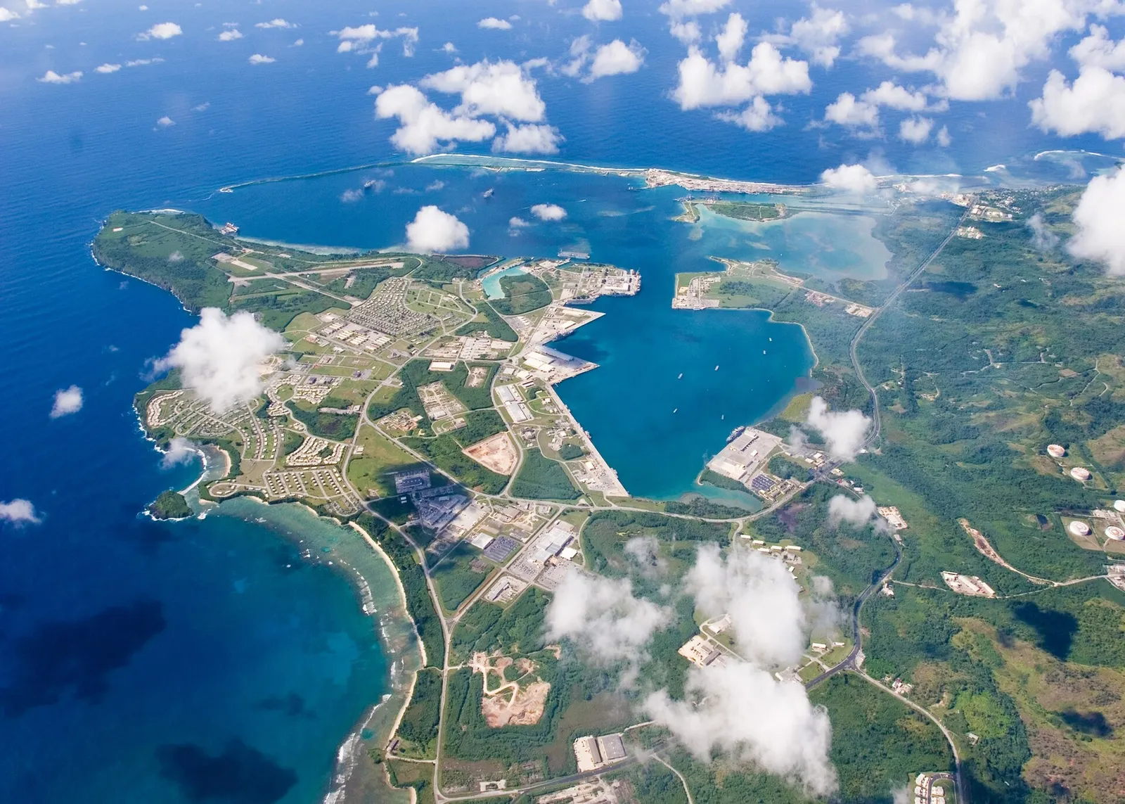 Aerial view of U.S. Naval Base Guam and Apra Harbor at Santa Rita, on the island's west coast